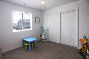 Playroom featuring carpet flooring and baseboards