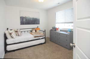 Bedroom featuring light colored carpet and baseboards