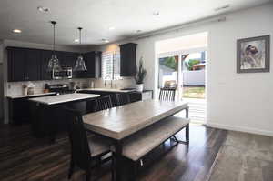 Dining room featuring dark wood-style flooring, recessed lighting, and baseboards