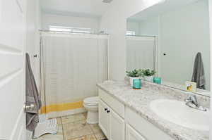 Full bathroom featuring vanity, toilet, and a shower with shower curtain