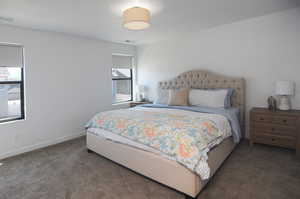Bedroom featuring carpet and baseboards
