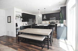 Dining room featuring dark wood-style floors, recessed lighting, and baseboards