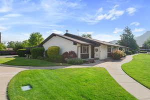 Single story home featuring a front lawn and brick siding