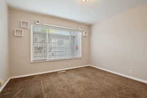 Unfurnished room featuring carpet flooring and baseboards