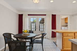 Dining area featuring independent washer and dryer, french doors, light tile patterned floors, recessed lighting, and baseboards