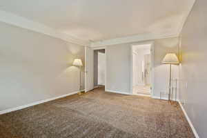 Unfurnished room with carpet flooring and baseboards