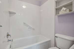 Bathroom with toilet and shower / bath combination