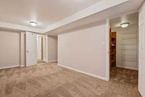 Unfurnished bedroom featuring carpet flooring and baseboards