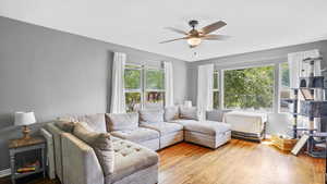 Living room with ceiling fan and wood finished floors