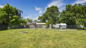 View of yard featuring an outdoor fire pit and an outdoor structure
