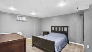 Bedroom with light colored carpet, baseboards, and recessed lighting