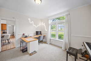 Office area featuring ornamental molding, light colored carpet, and baseboards