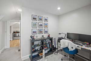 Office area featuring carpet floors, recessed lighting, baseboards, and lofted ceiling