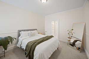 Bedroom with crown molding, carpet floors, and baseboards