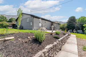 Rear view of house featuring a patio, central AC unit, and a mountain view
