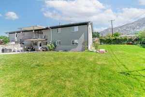 Rear view of house with a patio area, a mountain view, stairs, and brick siding