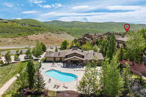 Aerial view of a mountainous background and a pool