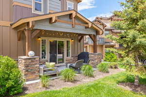 Back of house featuring board and batten siding and stone siding