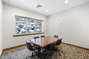 Carpeted dining area with baseboards and recessed lighting