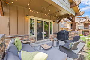 View of patio with a grill and outdoor lounge area