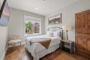 Bedroom with wood-type flooring, baseboards, and recessed lighting