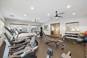 Gym featuring a ceiling fan, healthy amount of natural light, and recessed lighting