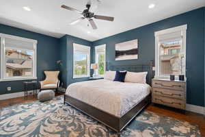 Bedroom featuring multiple windows, wood finished floors, baseboards, and recessed lighting