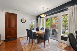 Dining room featuring wood finished floors, baseboards, and recessed lighting
