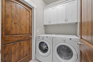 Laundry room with washing machine and dryer and cabinet space