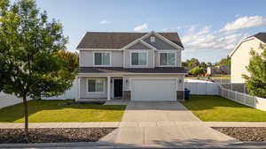 View of front of house featuring driveway, a garage, stone siding, and roof with shingles