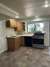 Kitchen featuring gas range, black dishwasher, light countertops, brown cabinetry, and open shelves