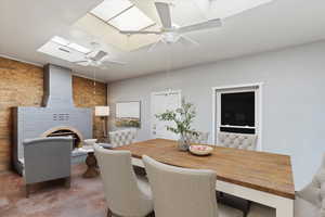 Virtually staged  Dining room featuring a skylight, ceiling fan, and brick wall