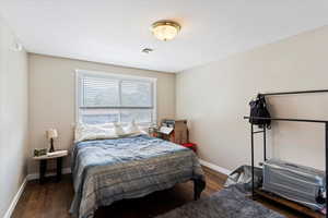 Bedroom featuring baseboards and wood finished floors