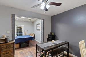 Bedroom featuring wood finished floors, baseboards, and ceiling fan