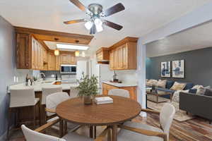 Virtually staged  Dining room featuring wood finished floors and ceiling fan