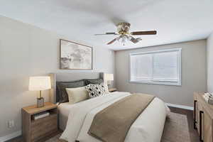 Virtually staged  Bedroom with baseboards, dark wood finished floors, and a ceiling fan