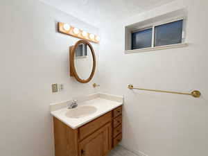 Bathroom with vanity and a textured ceiling