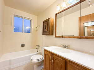 Bathroom featuring vanity, toilet, and bathing tub / shower combination