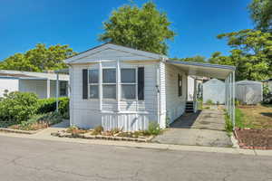 Manufactured / mobile home with driveway and a carport