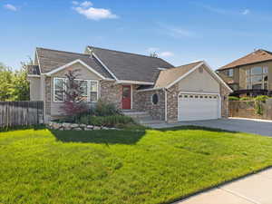 View of front of property with a shingled roof, driveway, a garage, brick siding, and stucco siding