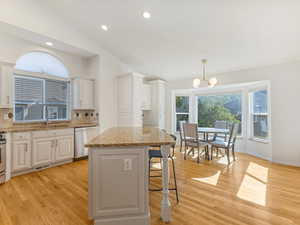 Kitchen featuring appliances with stainless steel finishes, a sink, tasteful backsplash, light wood-style flooring, and recessed lighting