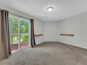 Carpeted spare room featuring baseboards and a textured ceiling