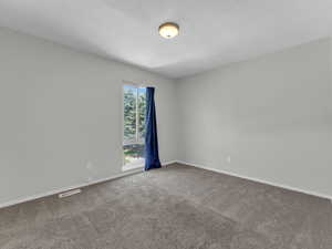 Unfurnished room with carpet floors and baseboards