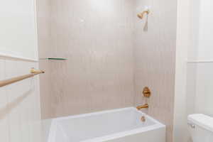 Full bath featuring toilet and tub / shower combination