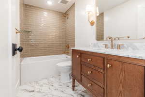 Full bathroom with vanity, toilet, shower / tub combination, and marble finish floors