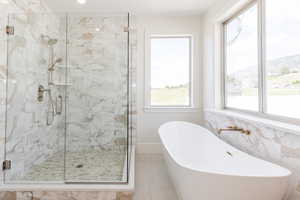 Bathroom with a stall shower, a soaking tub, and tile patterned floors