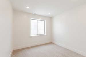 Unfurnished room with baseboards, light colored carpet, and recessed lighting