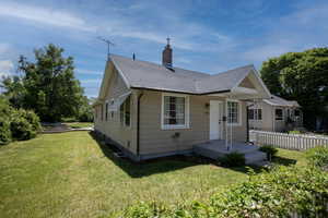 Bungalow featuring a chimney and a shingled roof