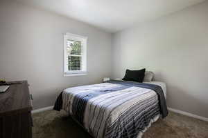 Carpeted bedroom with baseboards