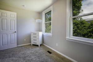 Unfurnished bedroom with carpet and baseboards